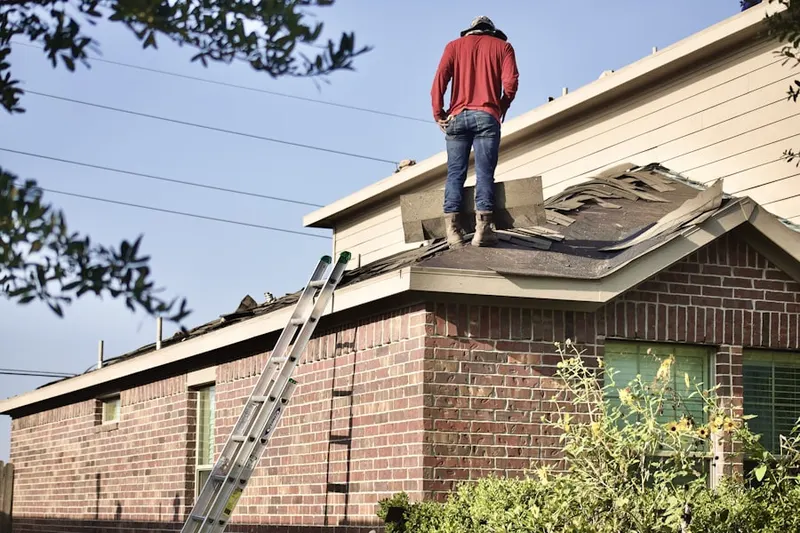 Professional roofer working on a residential roof in Wedgwood Middle